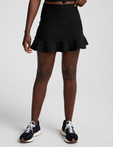 black high-waisted skirt with a ruffle hem and built-in shorts with pockets.
